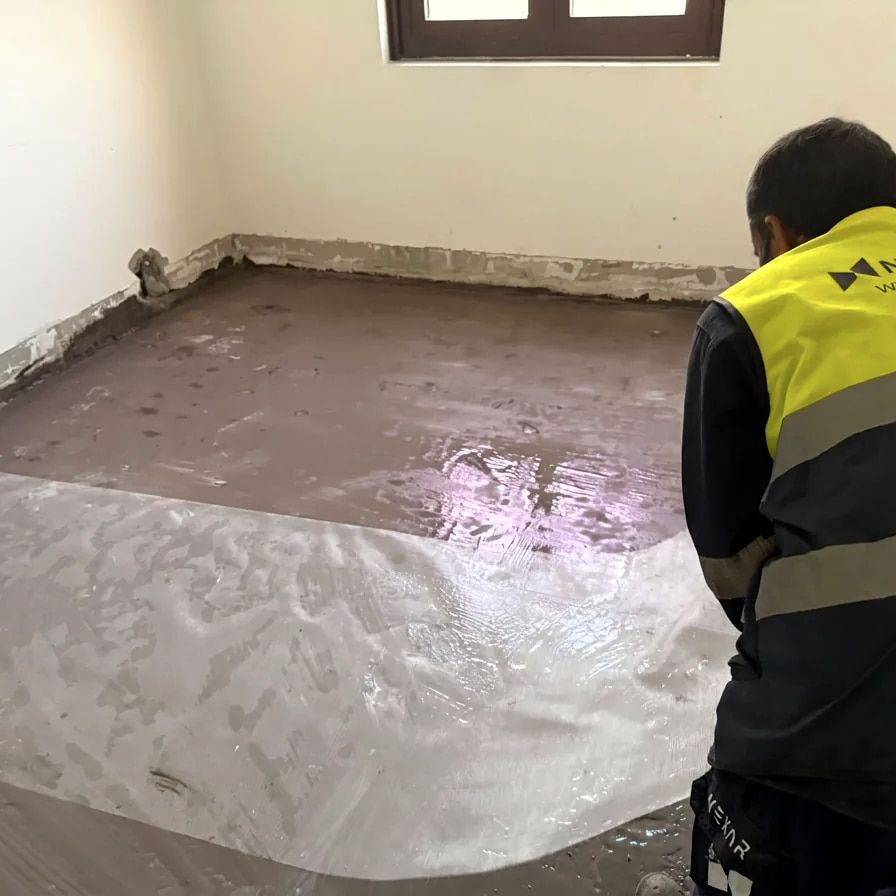 Nexar Flooring applicator laying resin across a room
