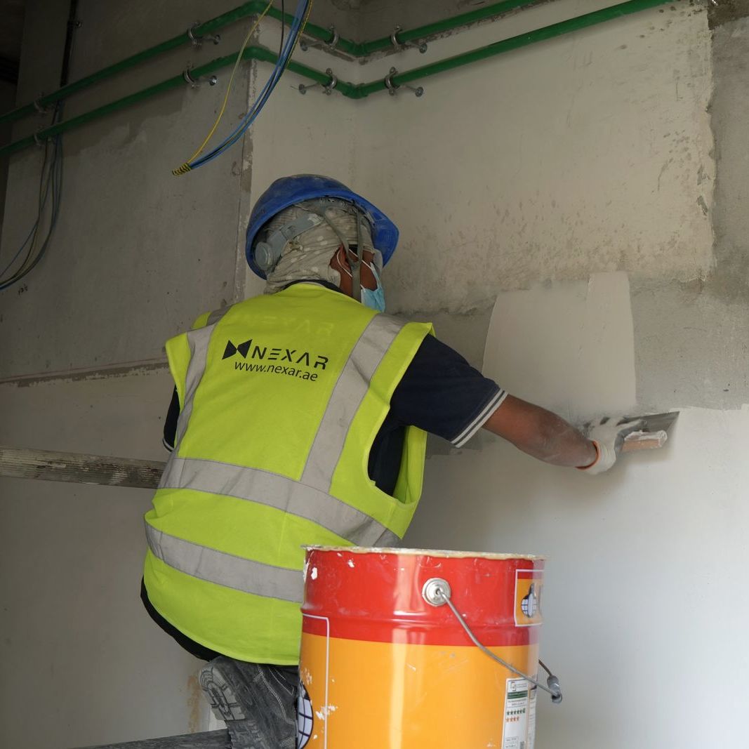 Nexar technician finishing a wall during an interior fit-out